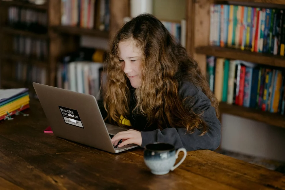 A student concentrating on schoolwork at a desk