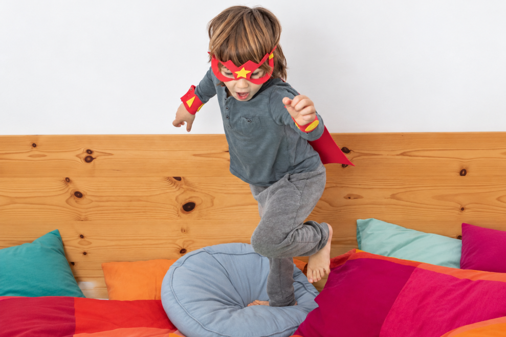 Child wearing a superhero costume during play