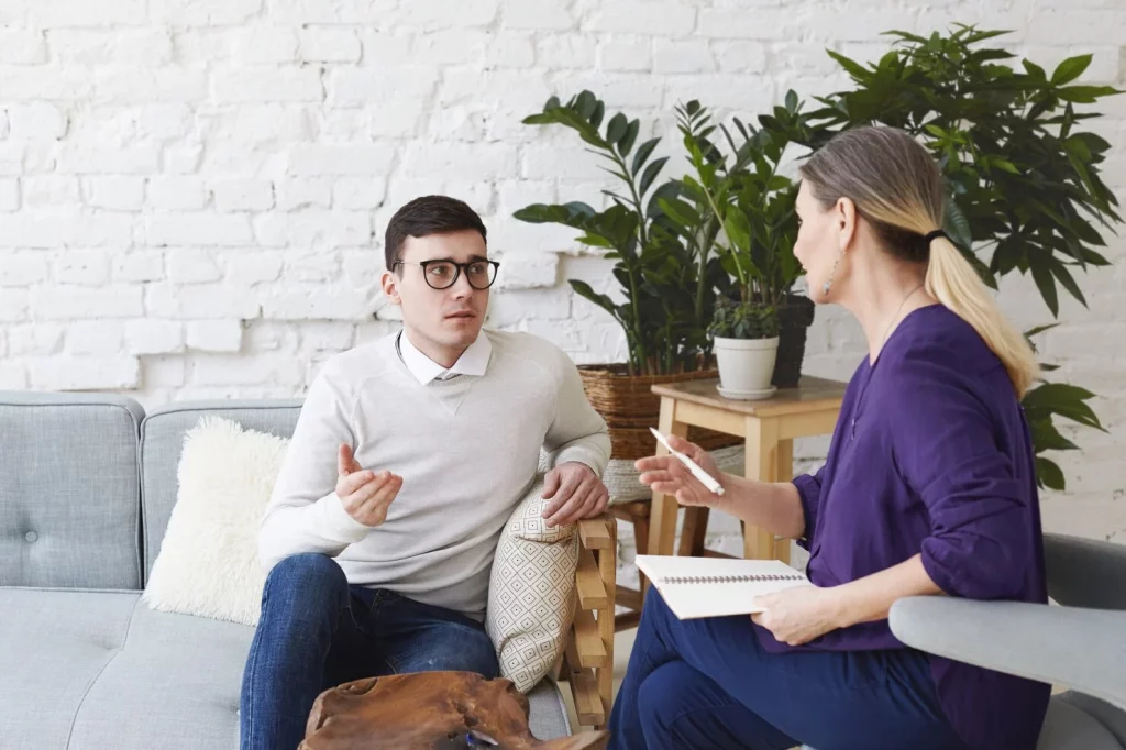 A clinician facilitating a group therapy session.