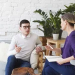 A clinician facilitating a group therapy session.