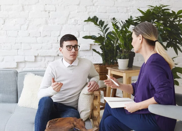 A clinician facilitating a group therapy session.