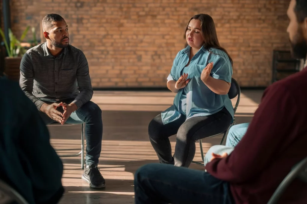 A clinician facilitating a group therapy session.