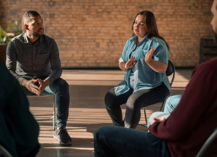 A clinician facilitating a group therapy session.