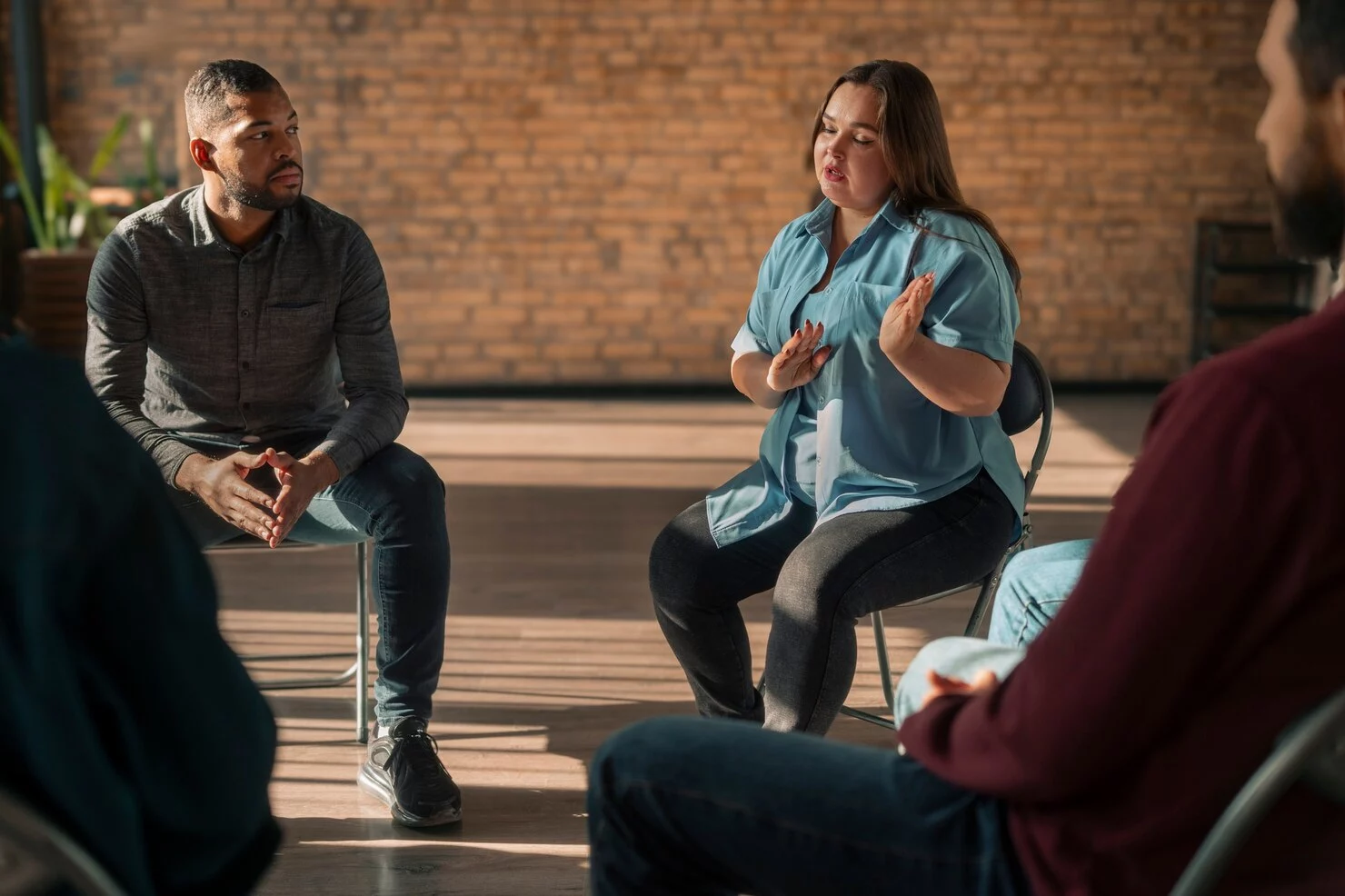 A clinician facilitating a group therapy session.